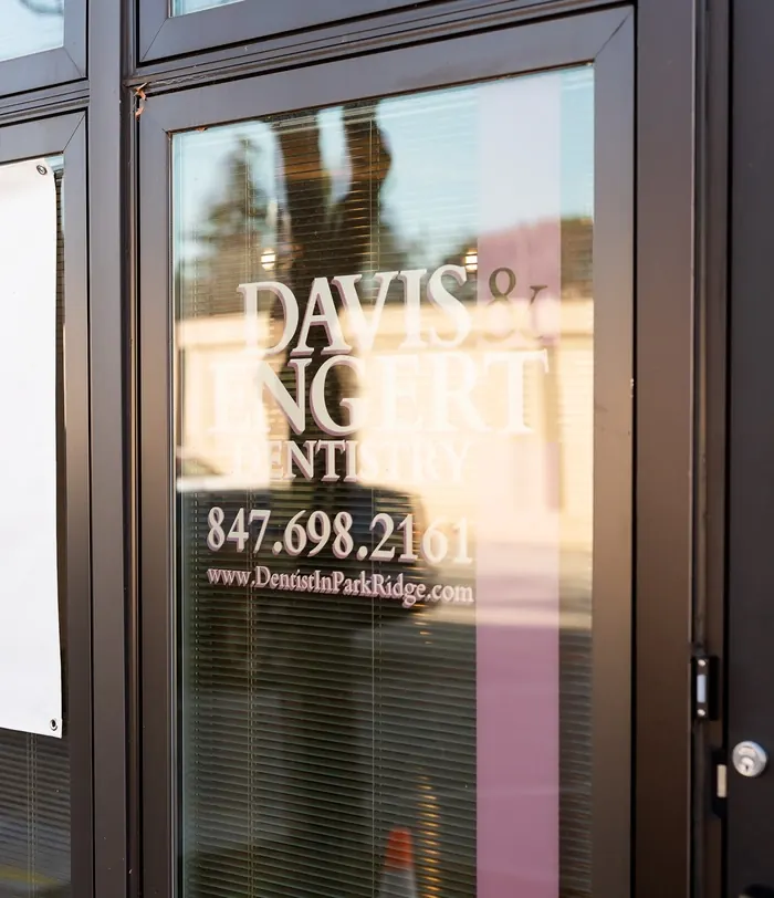 The front door of Davis & Engert Dentistry on Main Street, with the practice logo and phone number.