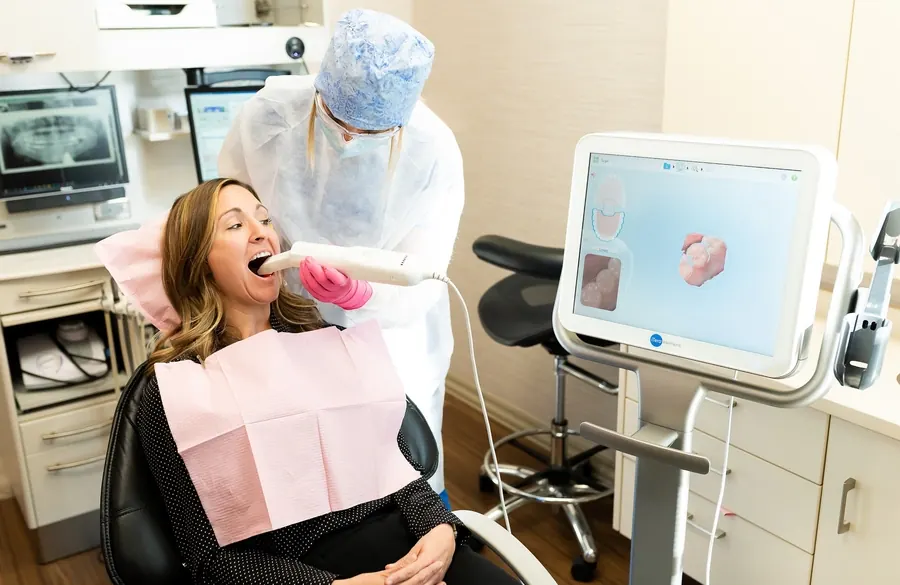 A patient at Davis & Engert having a digital scan, with a 3D model of her teeth on the screen.