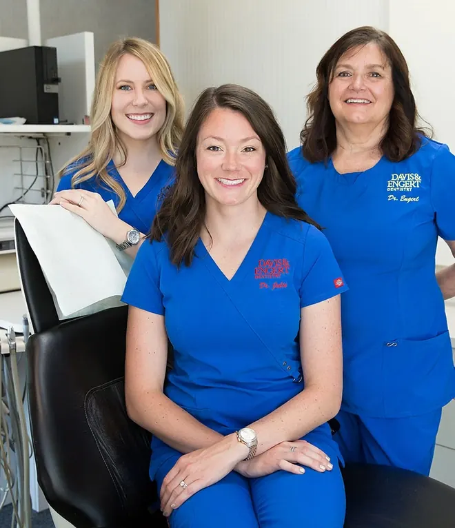 Dr. Julie Davis and Dr. Arlene Engert with a team member in a treatment room.